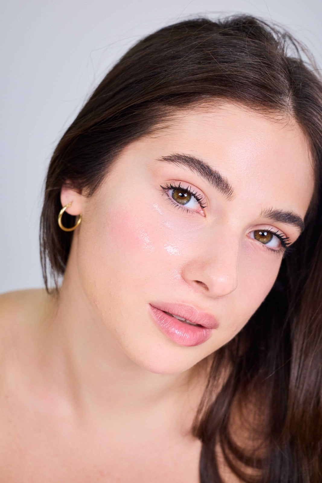 woman with healthy glowing skin after using advanced skincare treatments at home